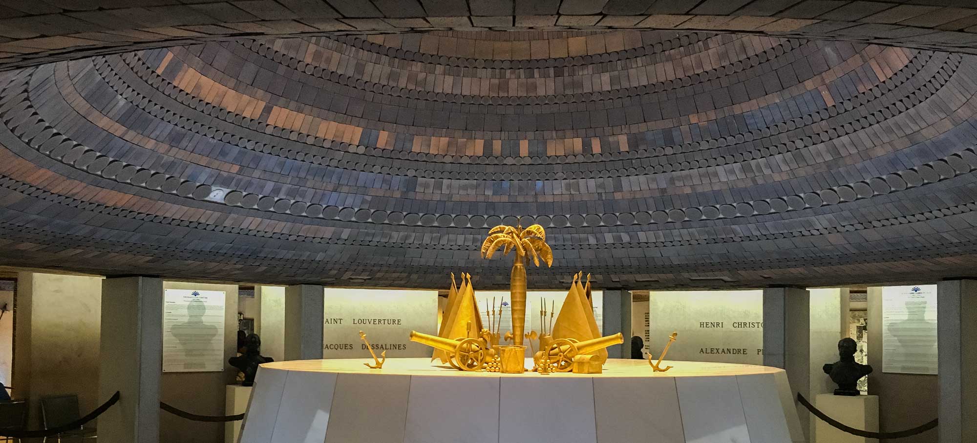 interior of haitian MUPANAH museum with golden sculptures