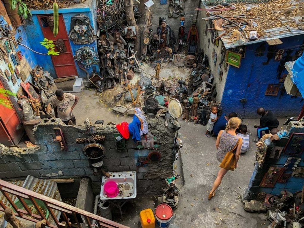 Tourist walking among sculptures on display at Atis Rezistans, Port-au-Prince, Haiti