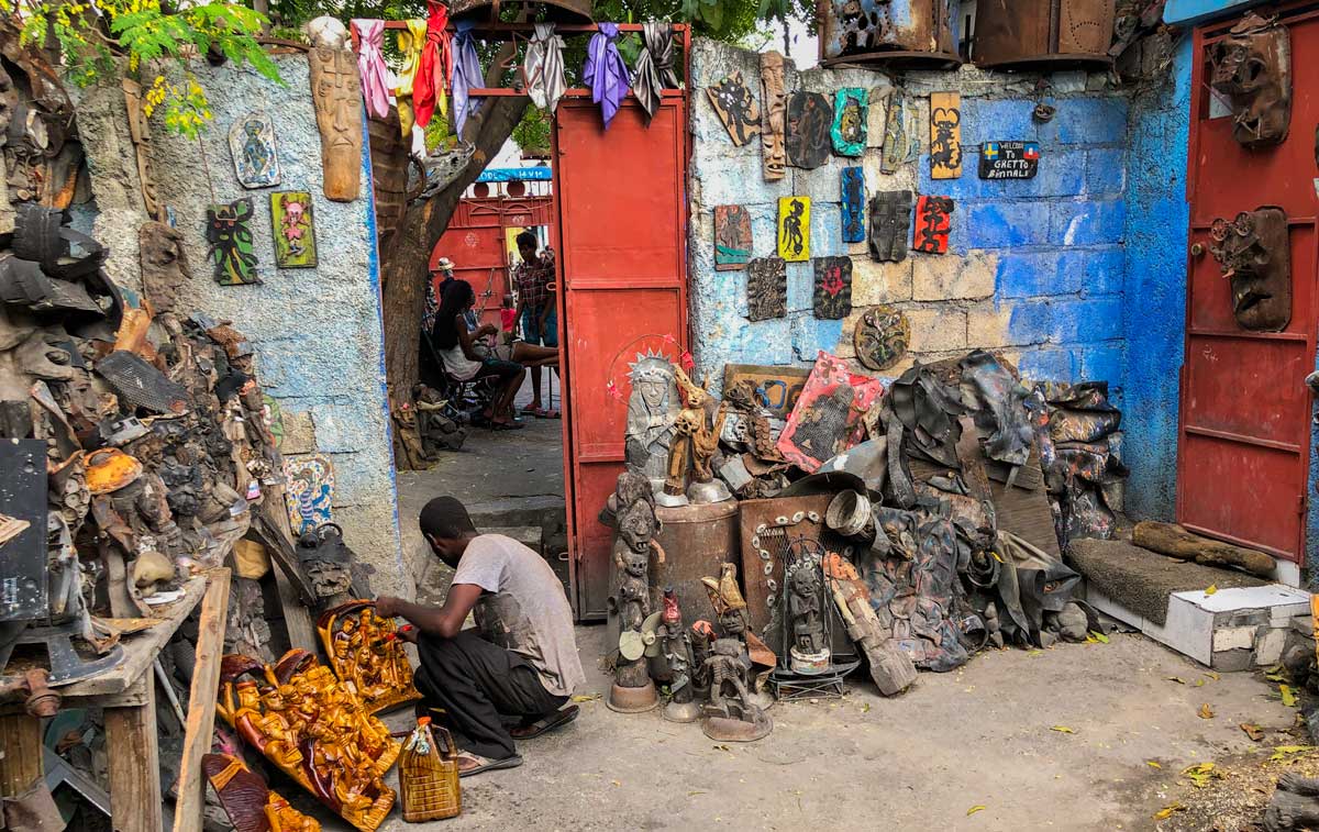 Artist working among sculptures on display at Atis Rezistans, Port-au-Prince, Haiti