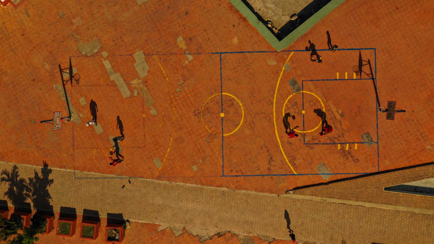 Aerial view of basketball players practicing on a court in Jacmel, Haiti