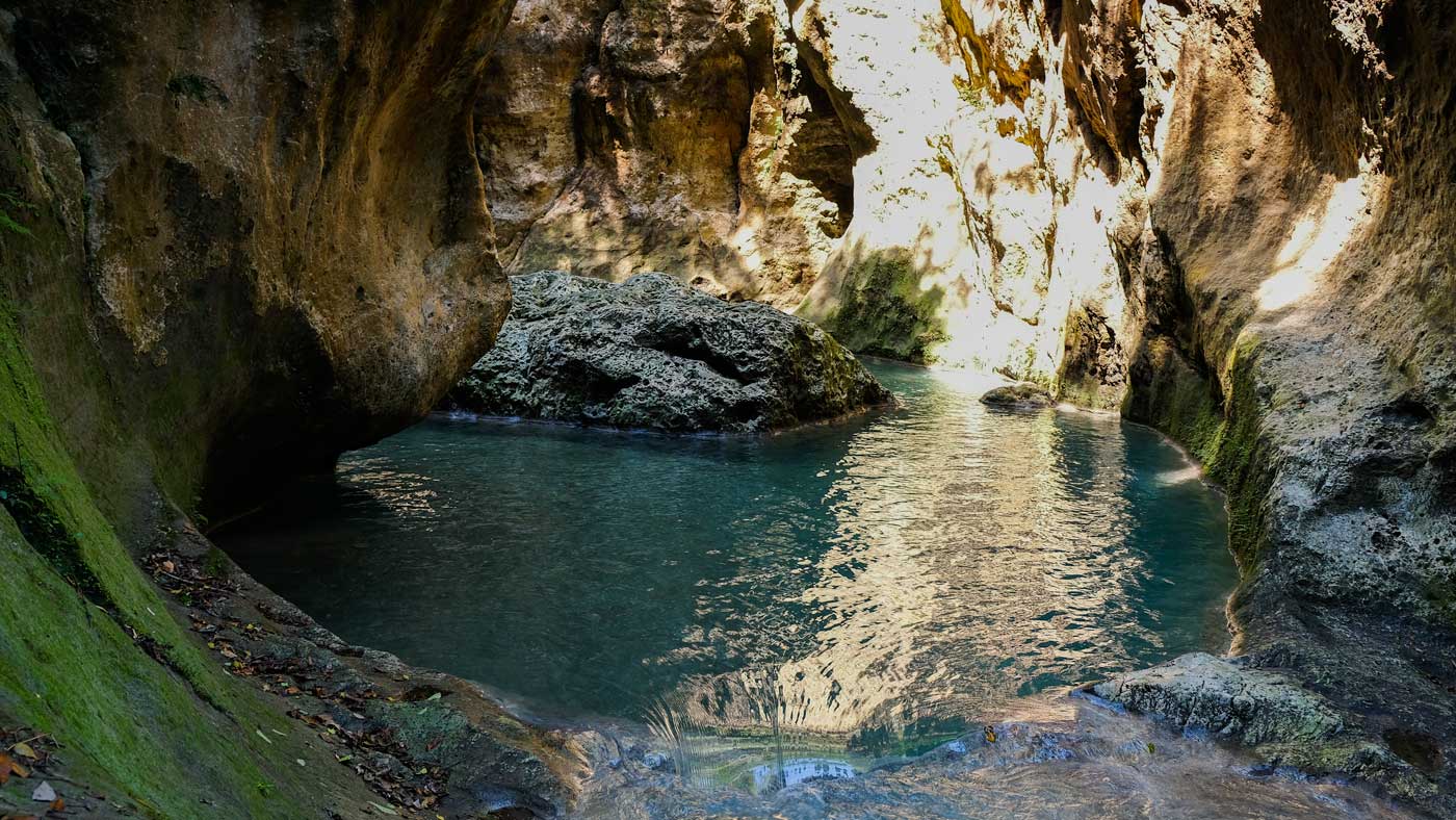 Pool surrounded by cliffs at