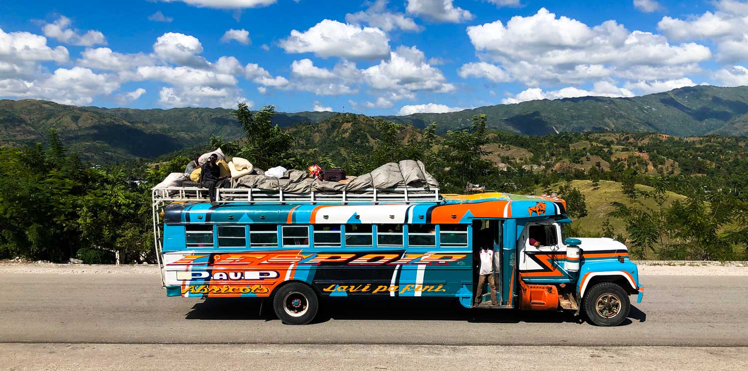 Colorful bus driving through rolling hills