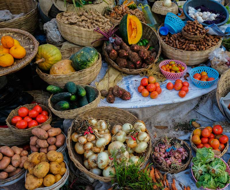 Piles of colorful fresh produce at a market in Fermathe, Haiti