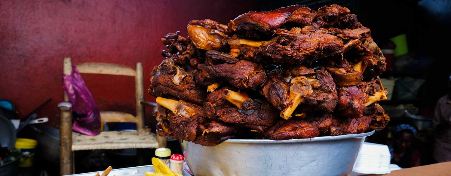 Fried meat on display at a street food stall in Haiti