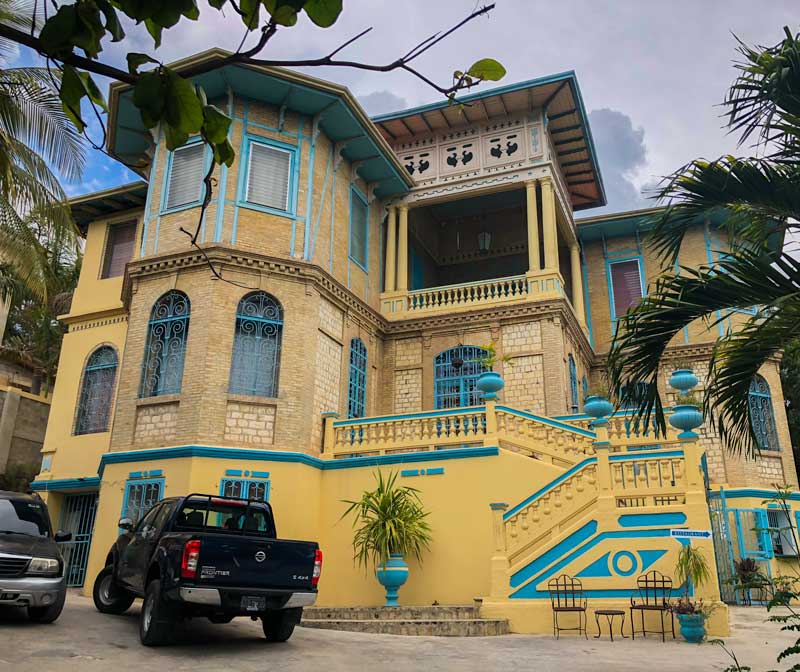 The yellow and blue exterior of Gingerbread Restaurant in Pacot, Port-au-Prince, Haiti