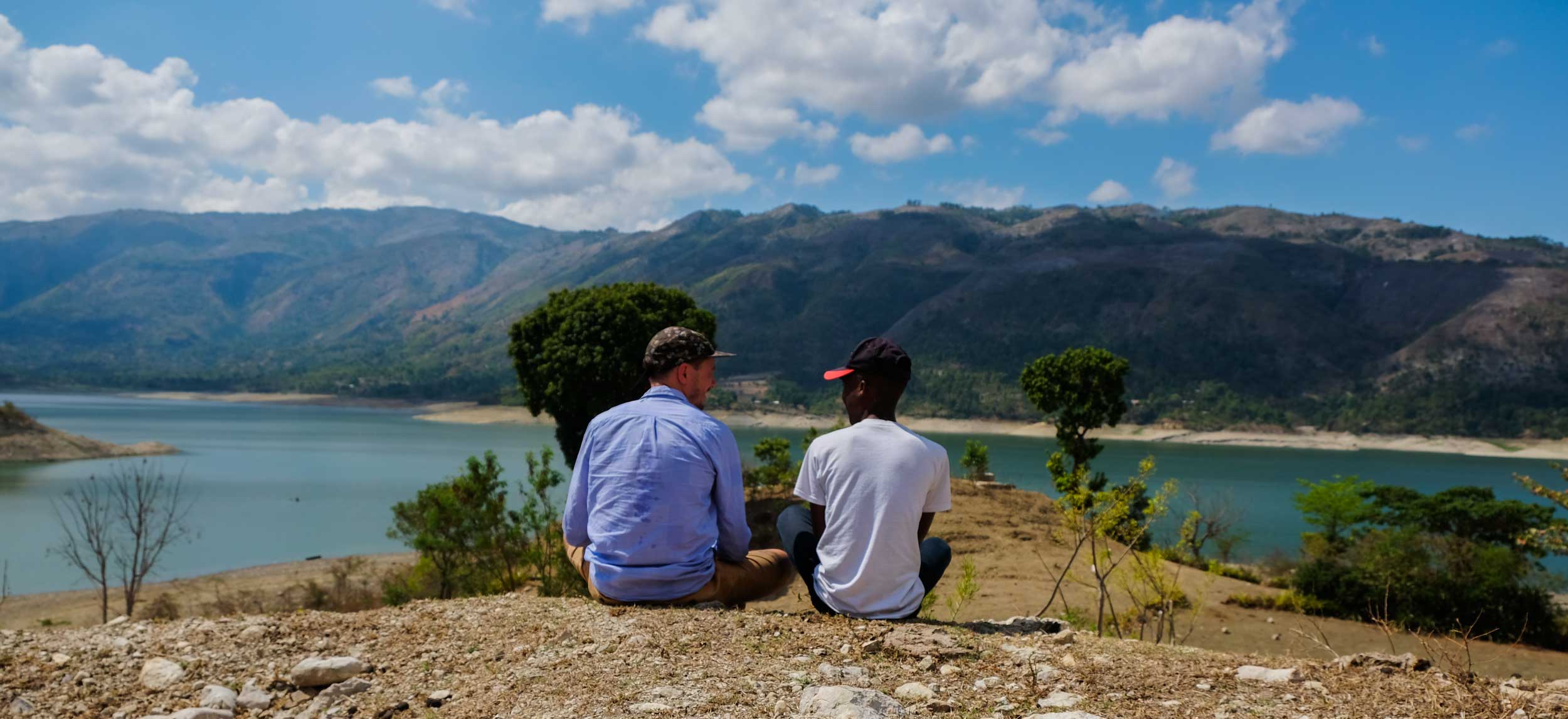 Two friends relaxing by Lake Péligre, Haiti