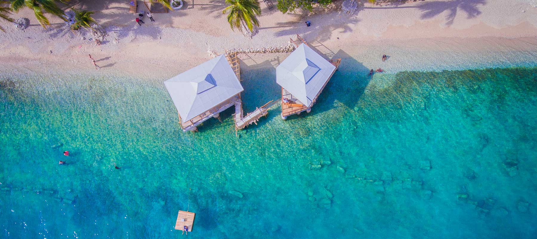 Aerial view of buildings on the water at Ouanga Bay, Carries, Haiti