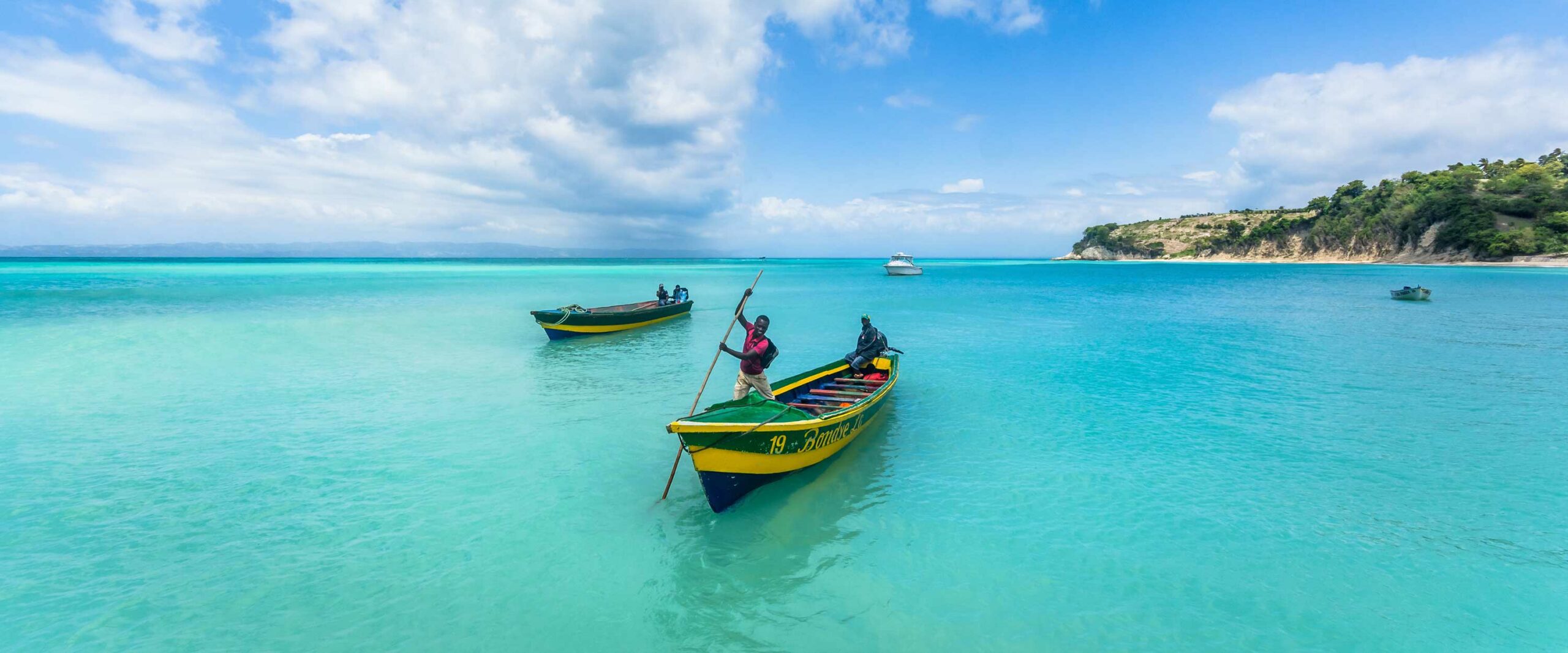 Boat taxis poling in to shore at Ile-a-Vache beach, Haiti