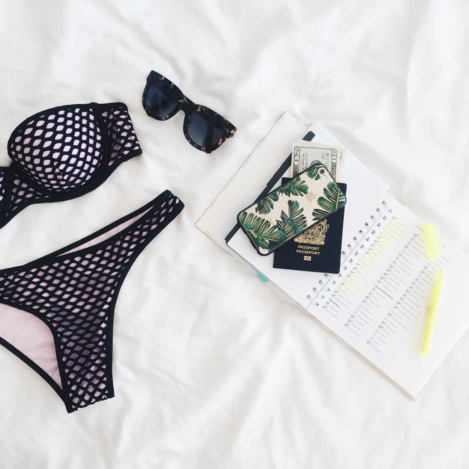 Flatlay of beachwear, diary and passport ready for vacation