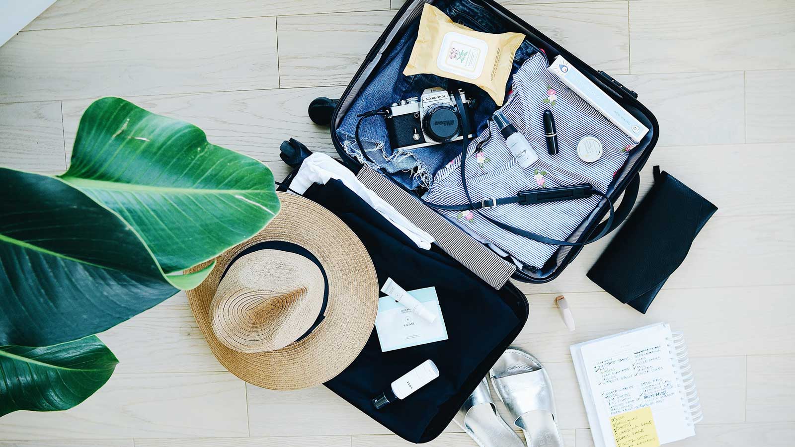 Flatlay of suitcase packing for vacation