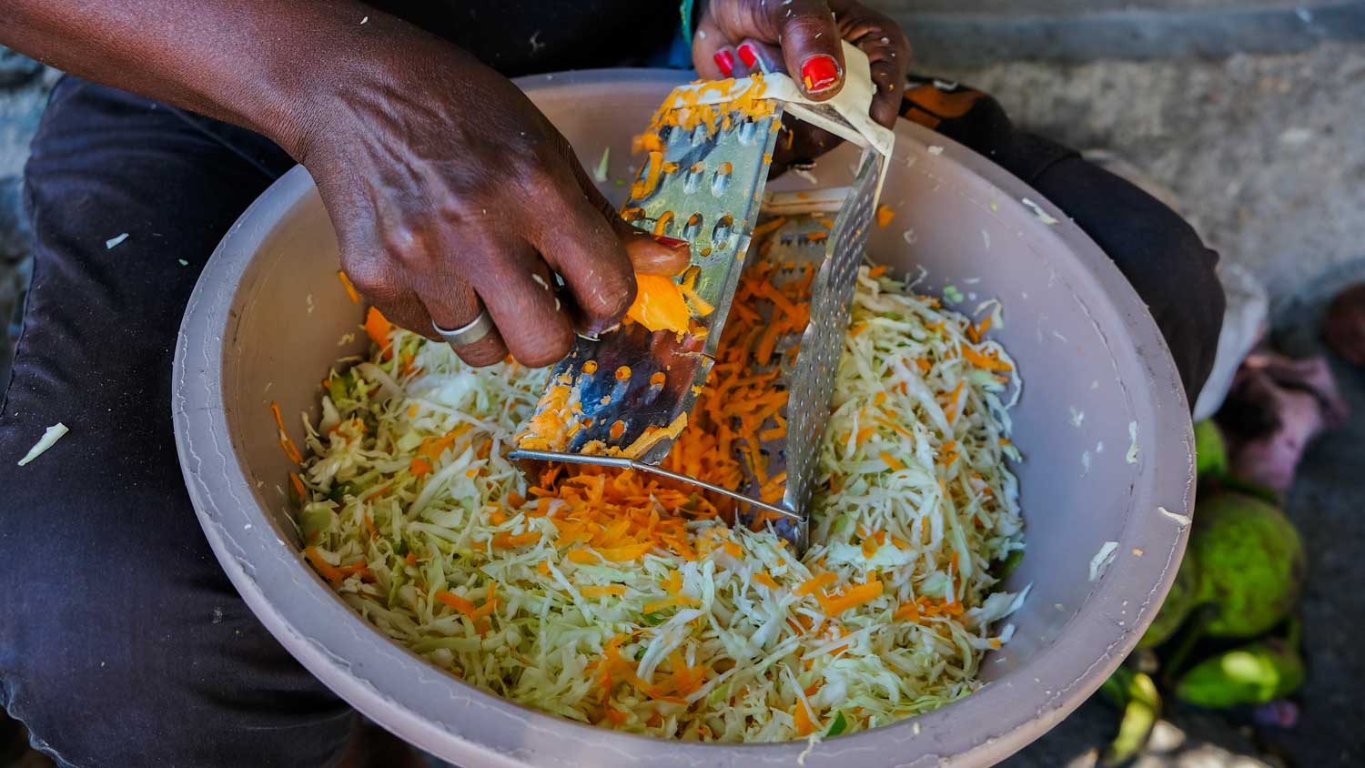 Woman making pikliz at a market in Jacmel, Haiti