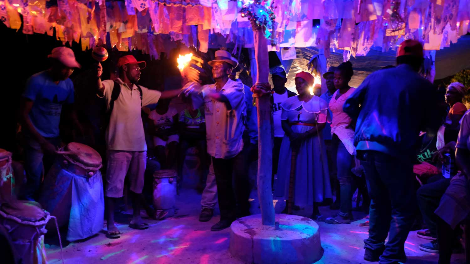 People gather around for a Vodou ceremony inside a Haitian Vodou temple in Petavie