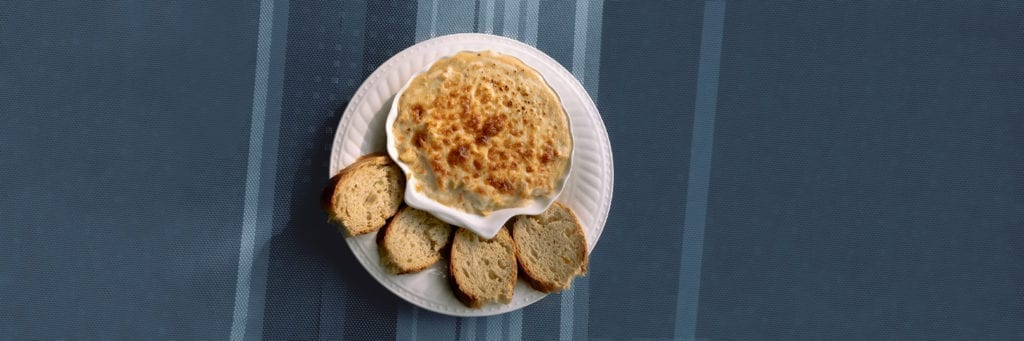 plate with conch gratine and slices of bread