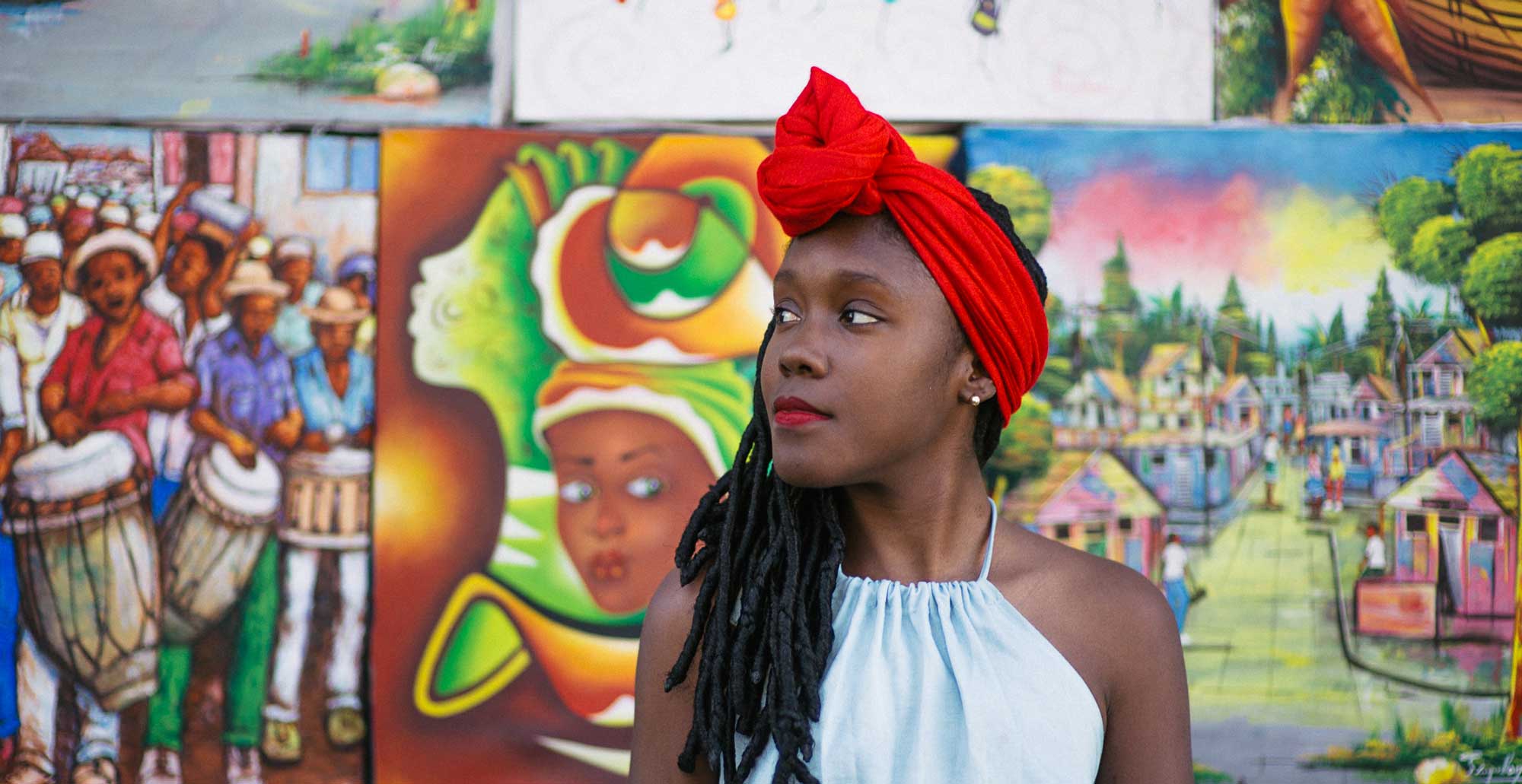 portrait photo of young stylish haitian girl with long dreadlocks and red head scarf