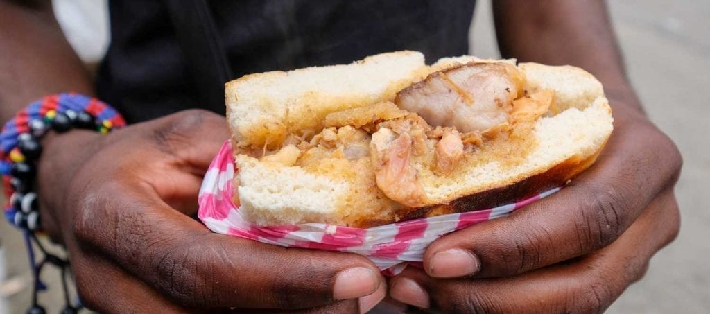 hands holding a sandwich with meat