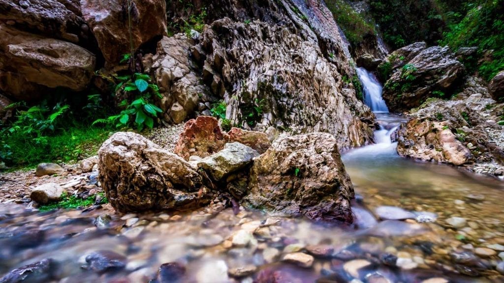 Waterfall plunges into a stony pool at Kaskad Boukan, Haiti