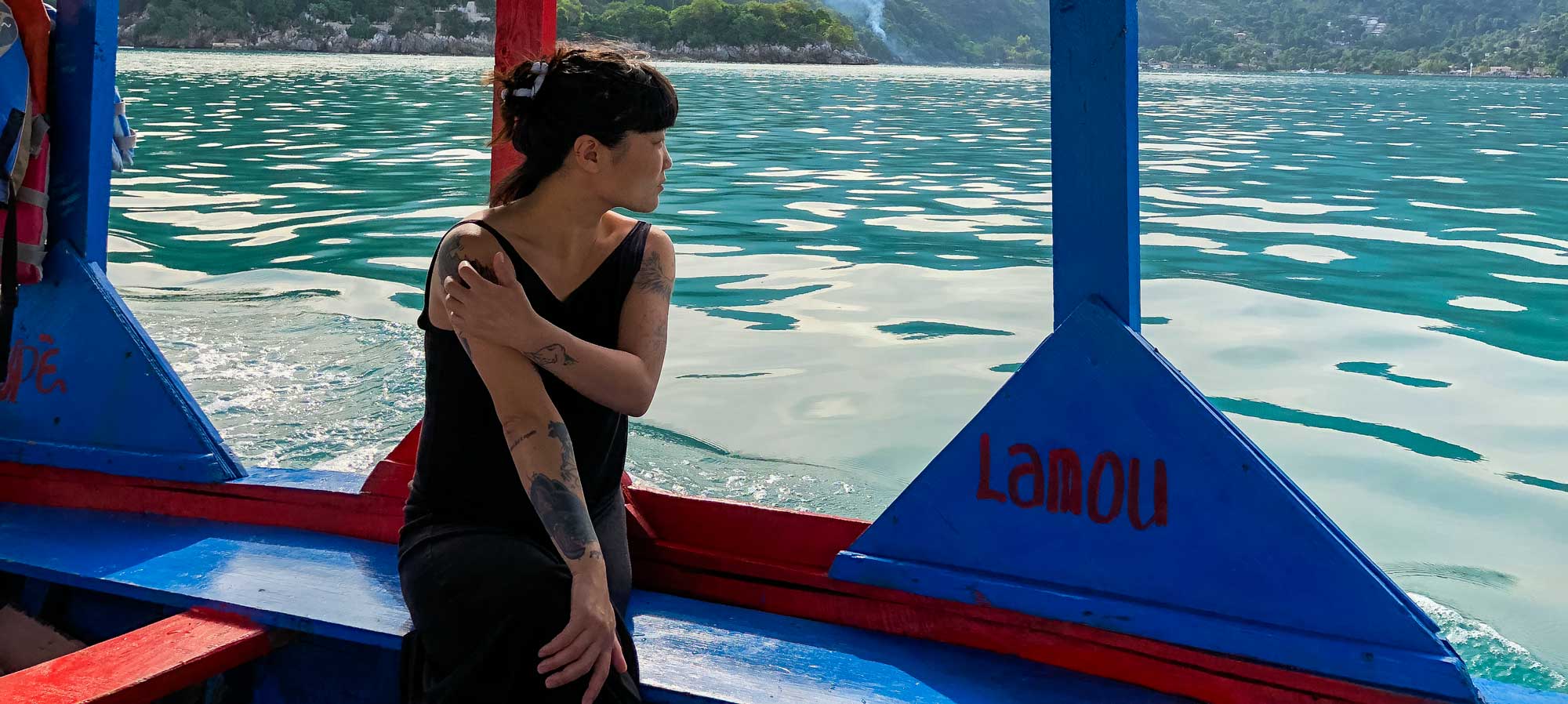 Woman looks out onto water while taking a water taxi in Labadee