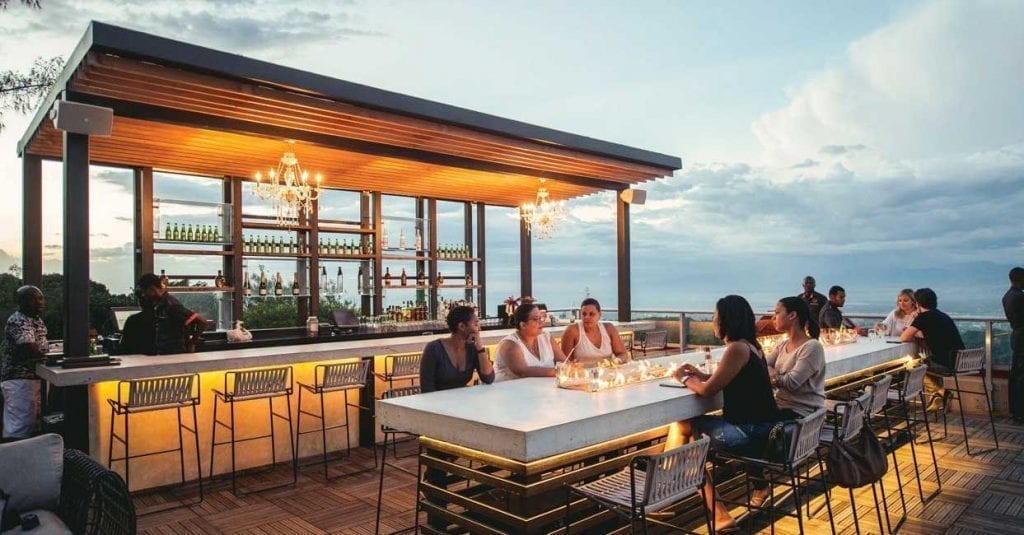 people relaxing on a hotel rooftop terrace