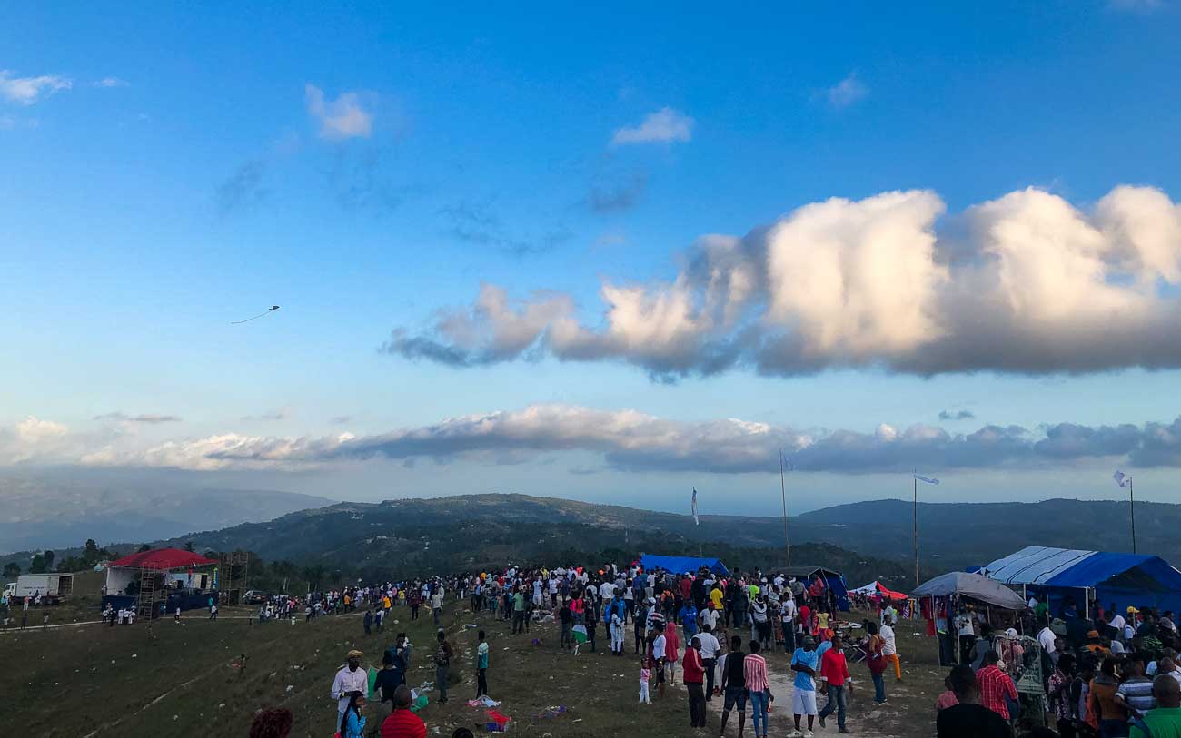 guests at a haitian kite flying festival on mountain top