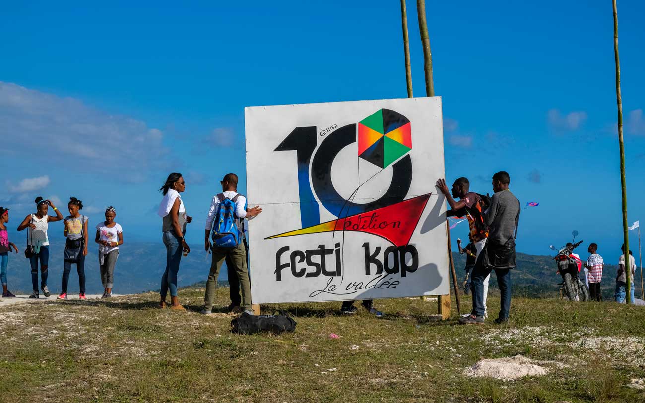 haitians on mountain setting up a festival sign