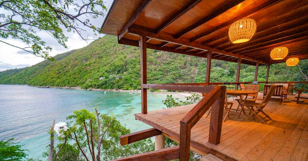 hotel veranda overlooking a small bay with mountains