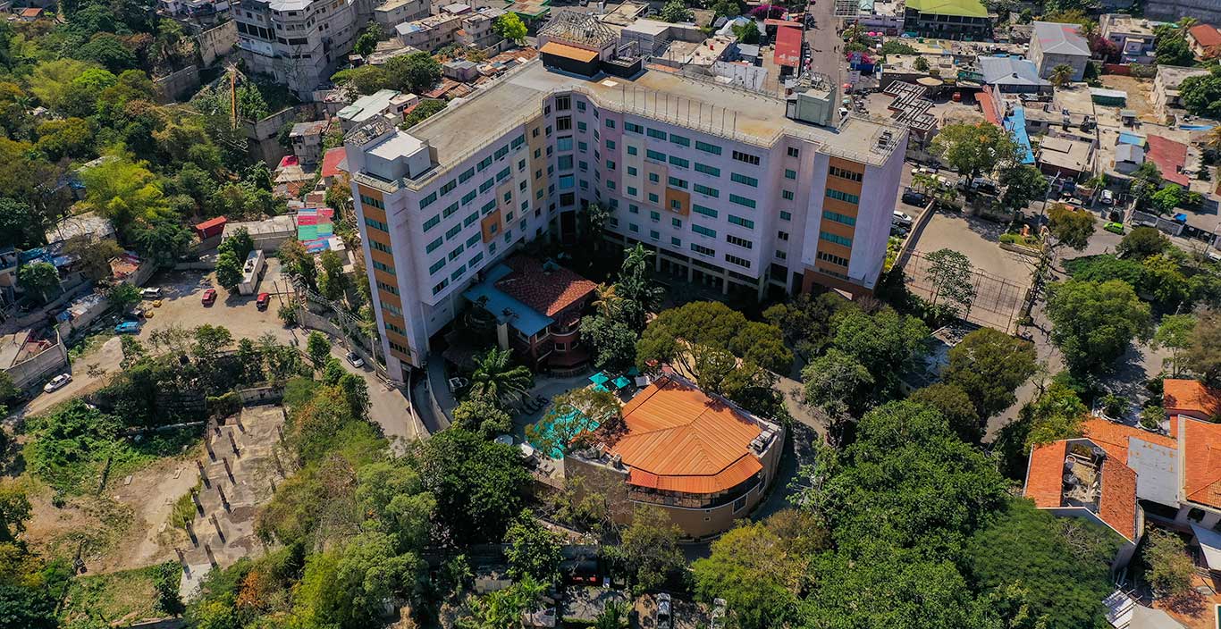 royal oasis hotel with lush green garden in urban area