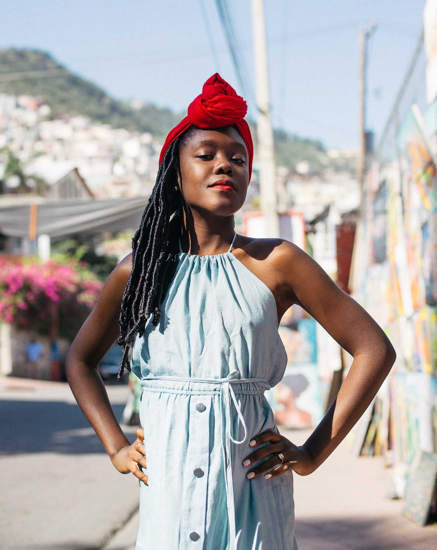 portrait photo of young stylish haitian girl with long braids and red head scarf