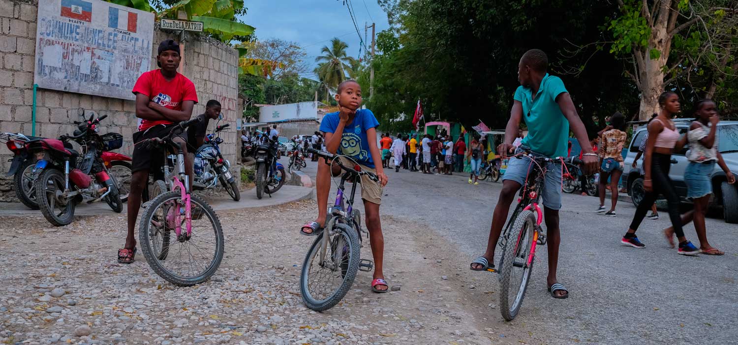 three haitian boys on bmx bikes