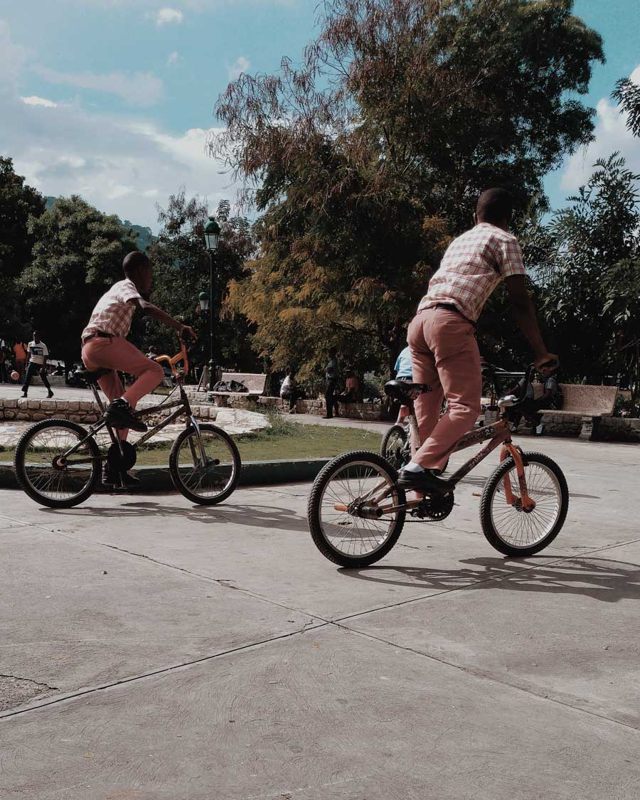 haitian boys in school uniforms on bmx bikes