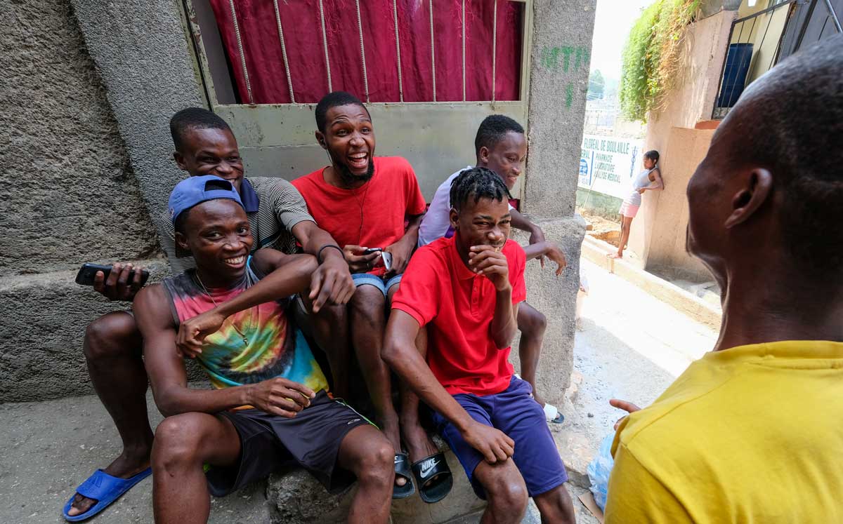 haitian boys sitting together laughing