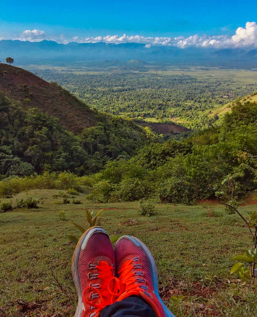 view over a lush green valley from a mountain top