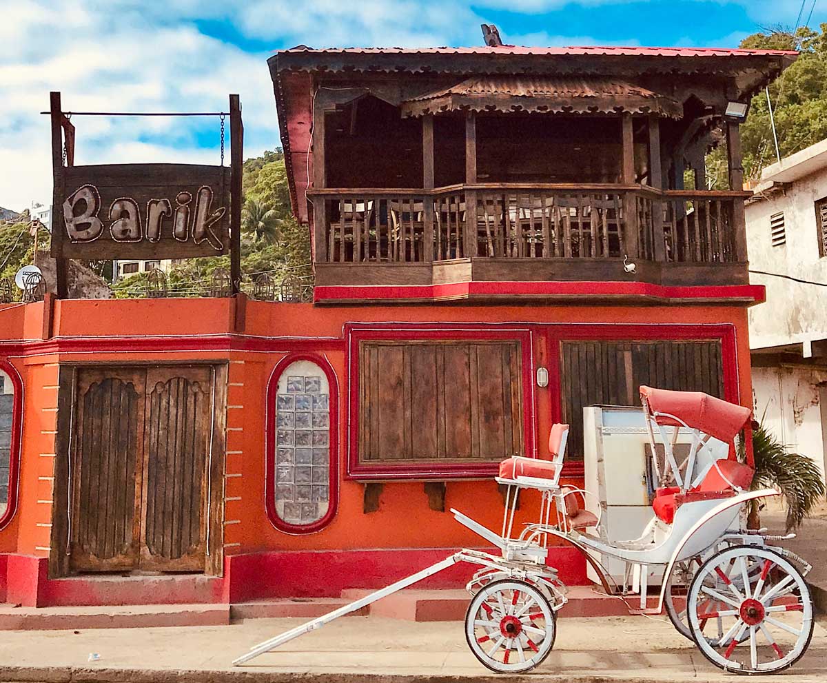 facade of a closed restaurant with old horse carriage parked in front