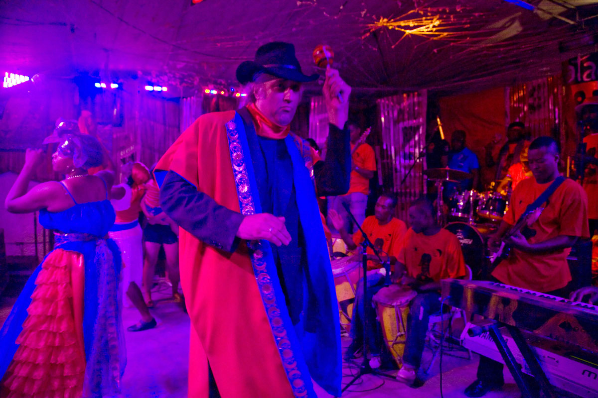 haitian musicians in red and blue dresses performing