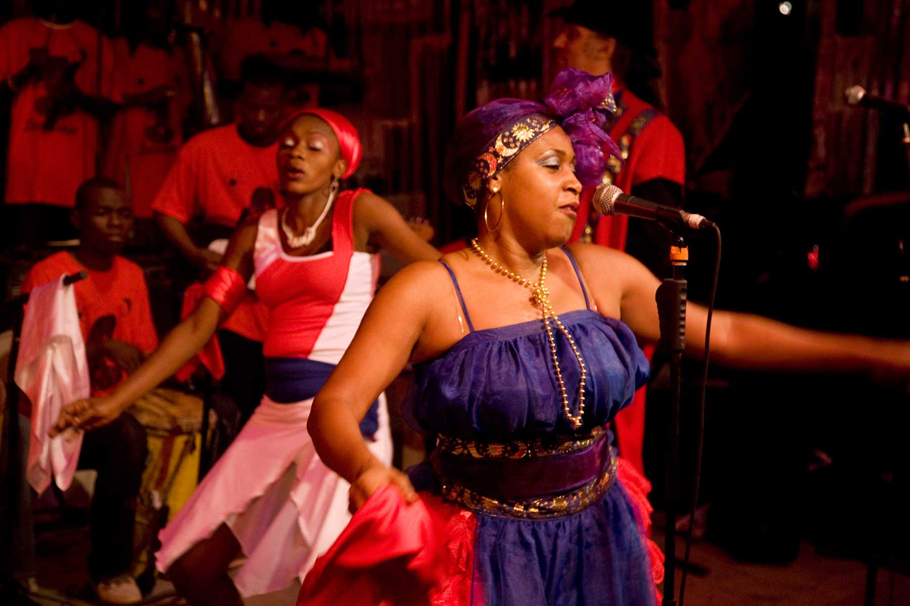 haitian lead singer in band dancing in front of microphone