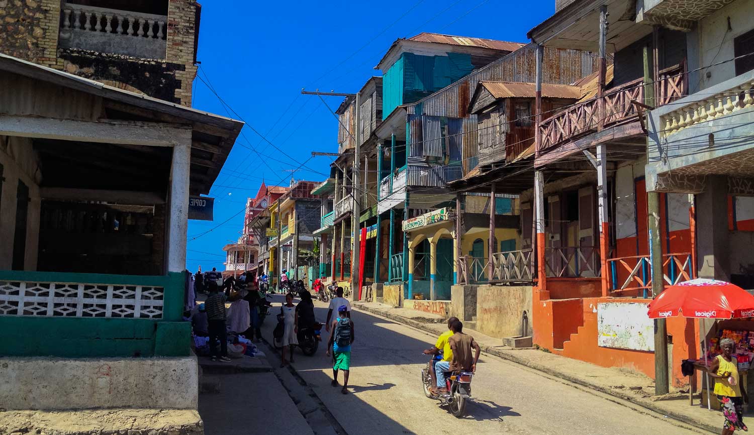 city street with people and old colonial houses