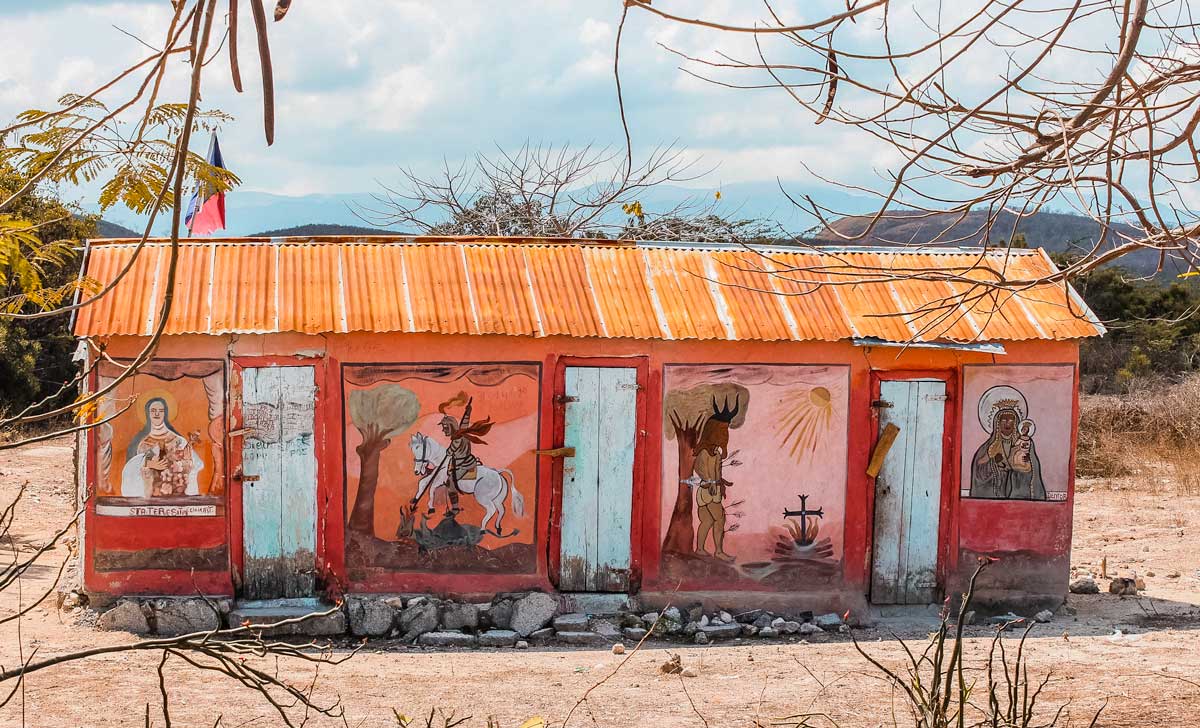 exterior of vodou temple with handpainted wall de