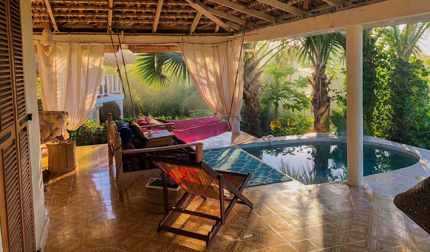 hotel veranda with small pool and hammock