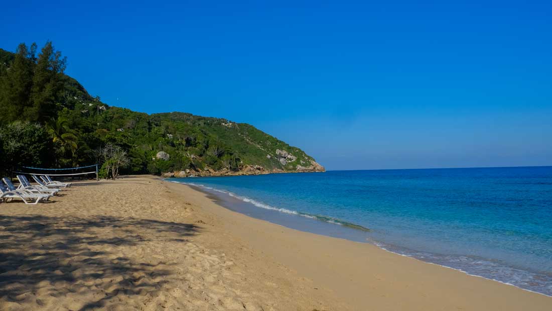 beach with lounge chairs and mountains