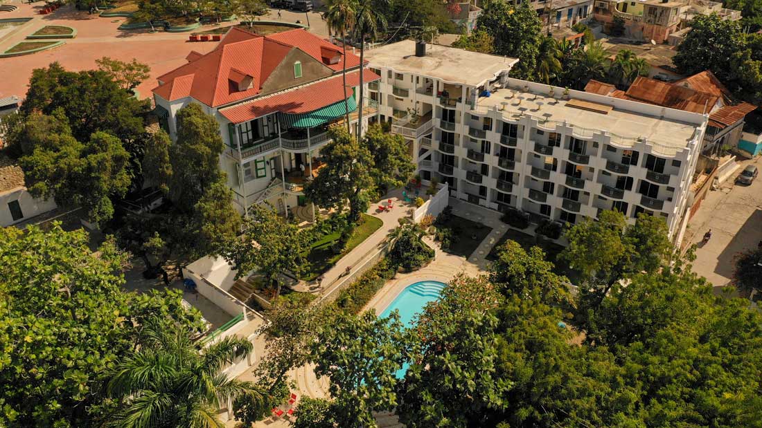 areal hotel buildings with a large pool and garden area