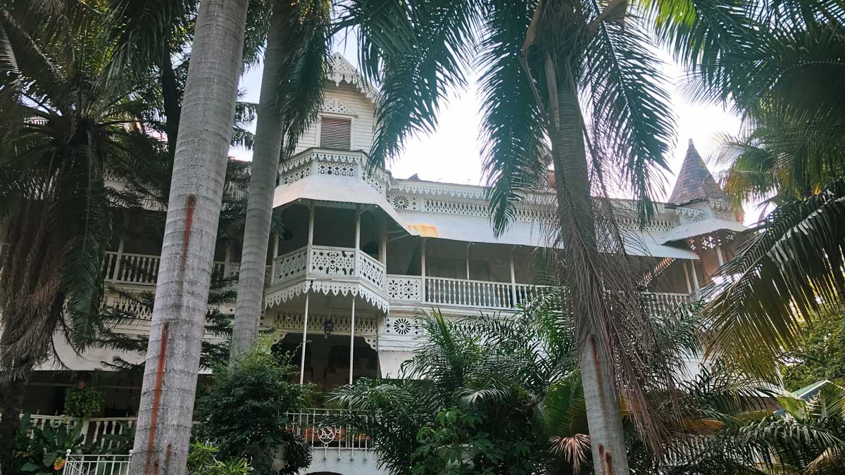 facade of gothic style gingerbread hotel with palm trees