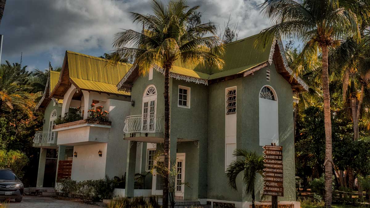 hotel building with balconies and green palm trees