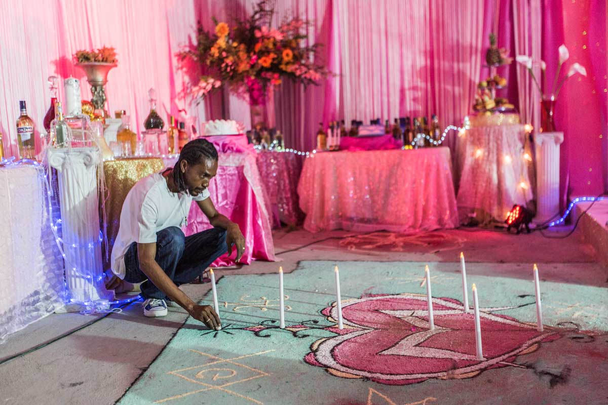 man lighting candles in a lavioushly 