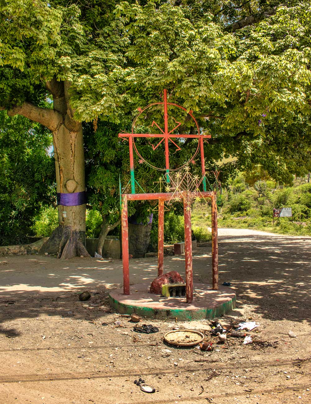 metal voddou sculpture with symbols and offerings to spirits