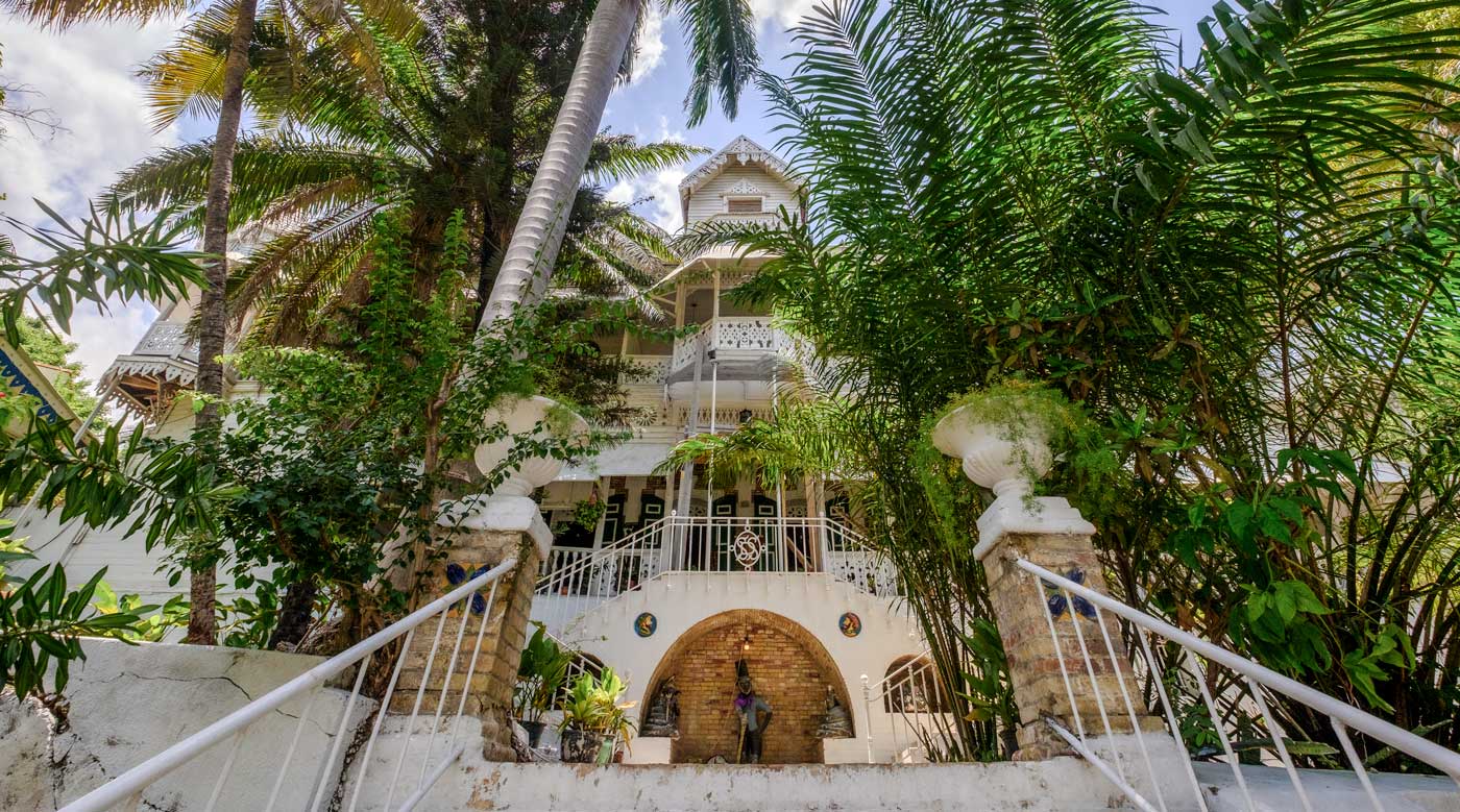 facade of gothic style gingerbread hotel with palm trees