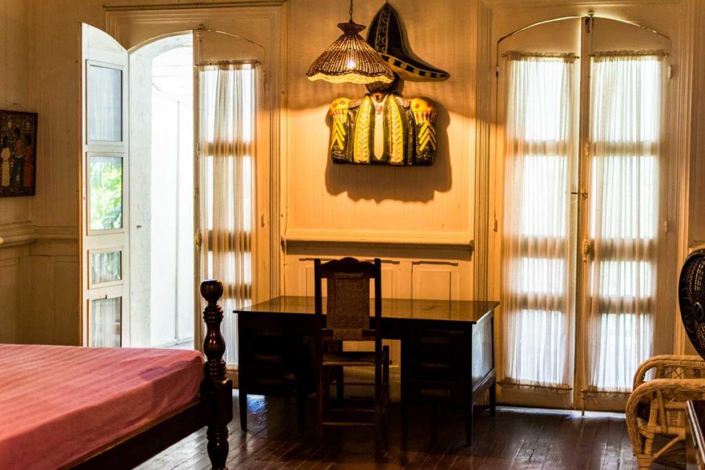 interior of hotel guest room with wodden desk and sunlight