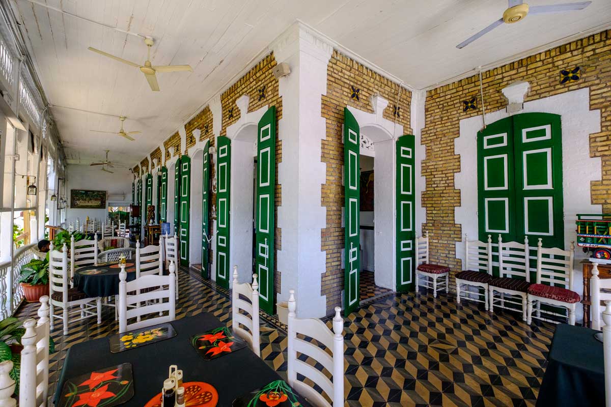 hotel restauarant veranda with tile floor green doors